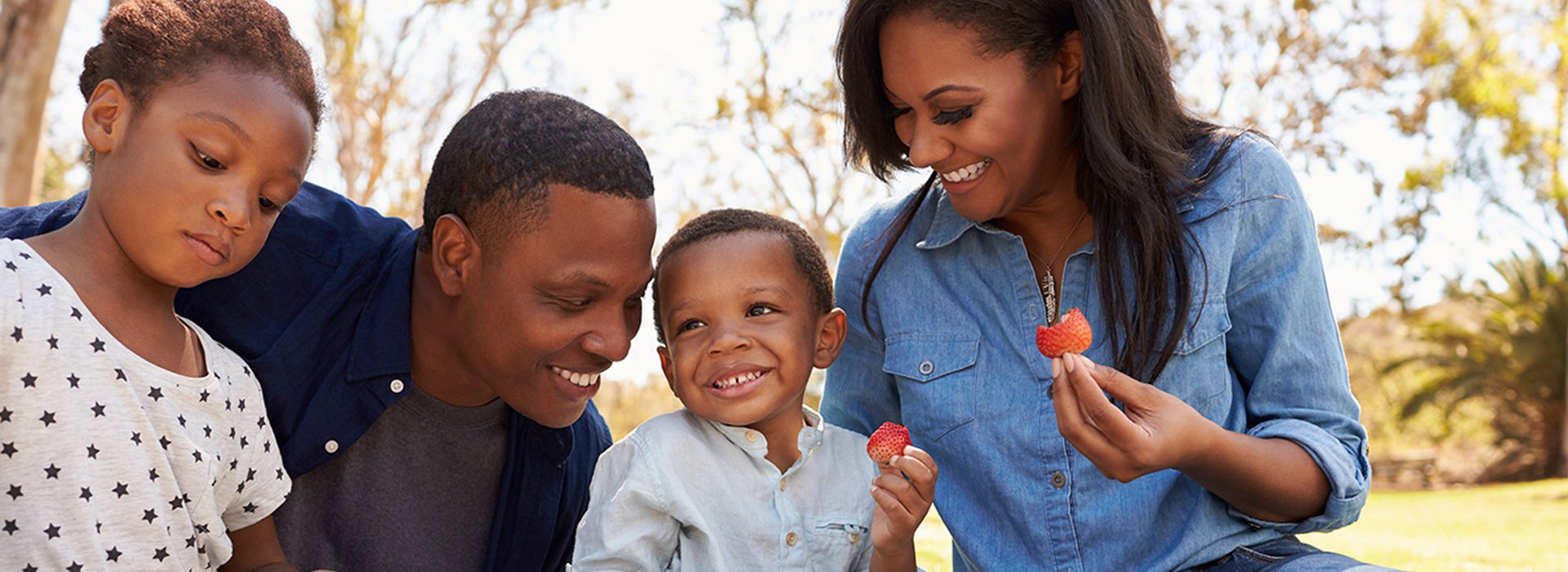 Black-father-and-son-playing-with-box-at-home